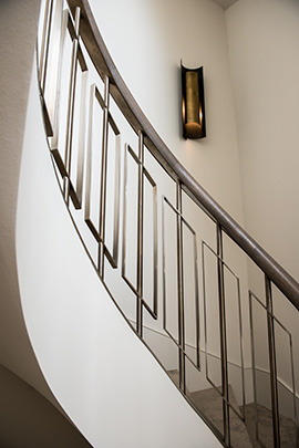 Showing the curved sweep of the staircase with balustrades in Almond Gold stainless steel