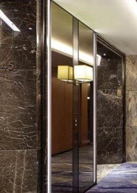 Call Button panel in V-grooved and folded Bronze PVD stainless steel in the Shangri La Hotel at the Shard, London