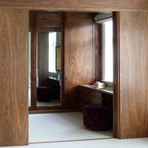 A walnut dressing area with a mid-20th century feel in a Listed Victorian house in Bedford Park, Chiswick.