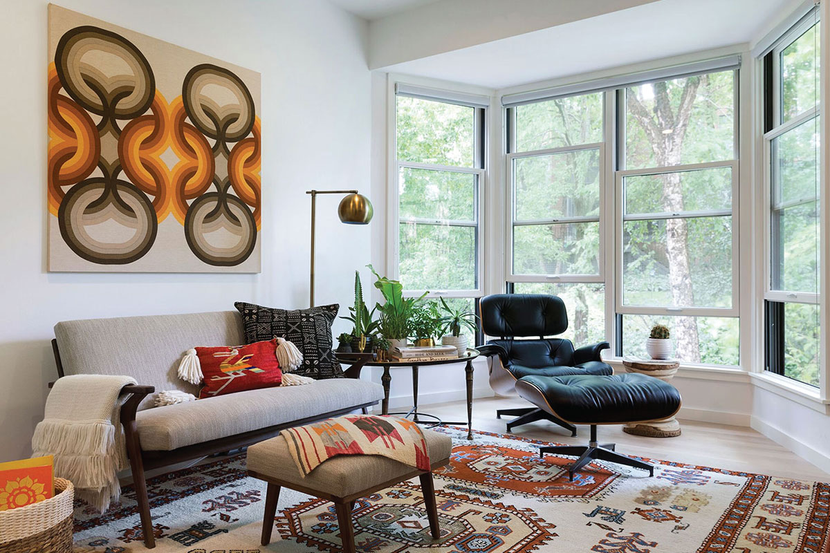 Sitting room in a Collector’s Loft Apartment by Lucy Interior Design, Minneapolis. Tribal meets mid-century modern set against a clean white palette.