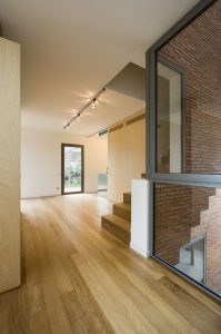 Family house and home office. Floors and panels finished in wood bring warmth to the interior space. Architecture and Interior design by Bach Arquitectes + Antonio Moll