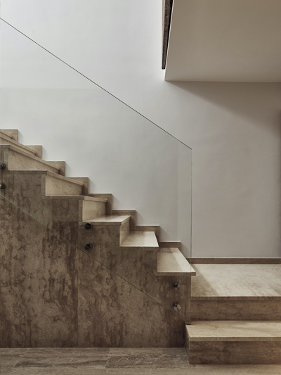 Casa Auxilar & Spa, Catalunya, Spain by Base Interiors - This stone staircase and glass balustrade illustrate the pared-back detailing with emphasis on natural materials with solid, reassuring dimensions for a spa resort in Spain.
