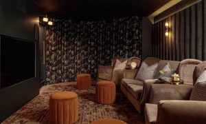 Decadent home cinema room with considered design & acoustics. In-house team of curtain makers produced blackout lined curtain. Interior design by Pfeiffer Design.